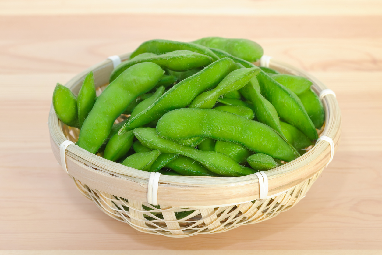 Boiled green soybeans (edamame) in a small bamboo basket. Often found in Japanese restaurants and some Chinese restaurants.