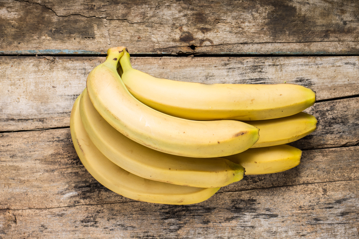 Bunch of Bananas on Grunge Wooden Background. Top View
