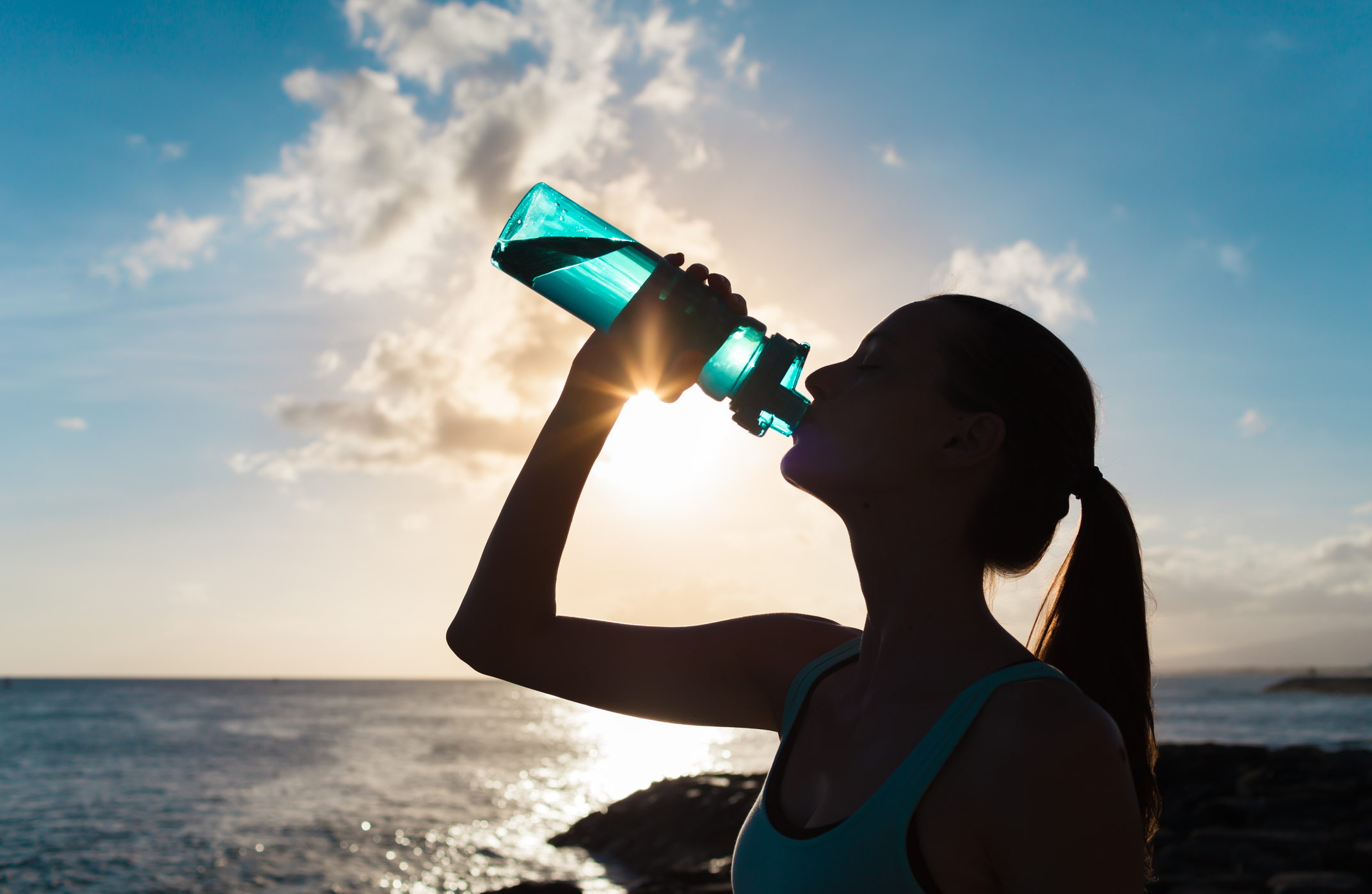 Woman drinking water during workout.