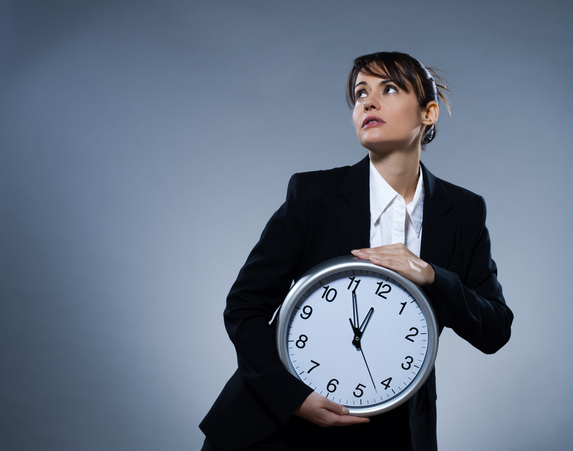 beautiful woman on isolated backgound holding a clock