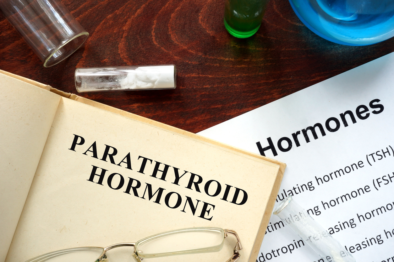 Hormone parathyroid hormone (PTH) written on book. Test tubes and hormones list.