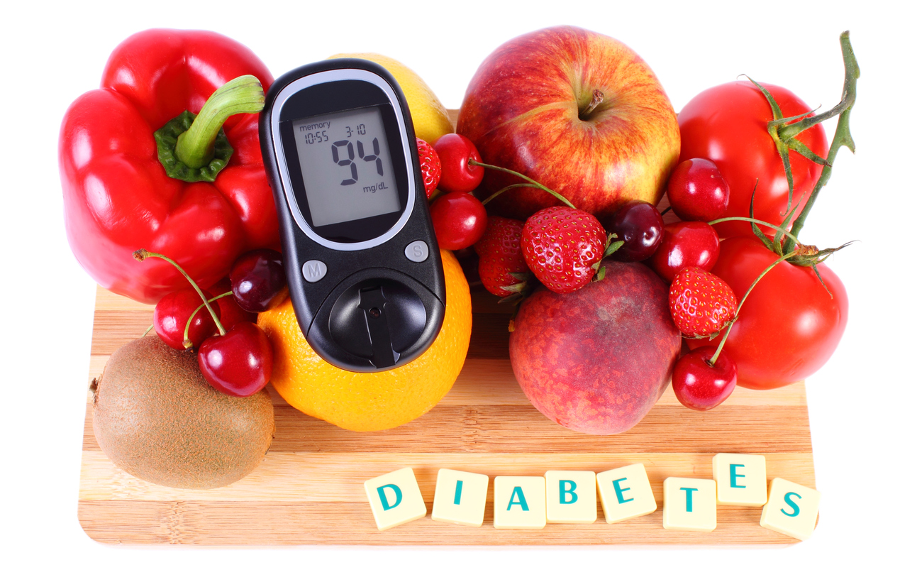 Glucometer with fresh ripe fruits and vegetables on wooden cutting board, concept of diabetes, healthy food, nutrition and strengthening immunity