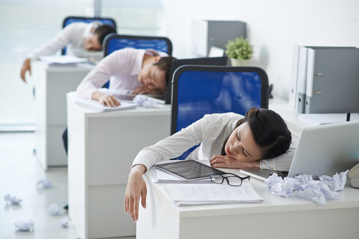 Asian business people sleeping at their workplaces