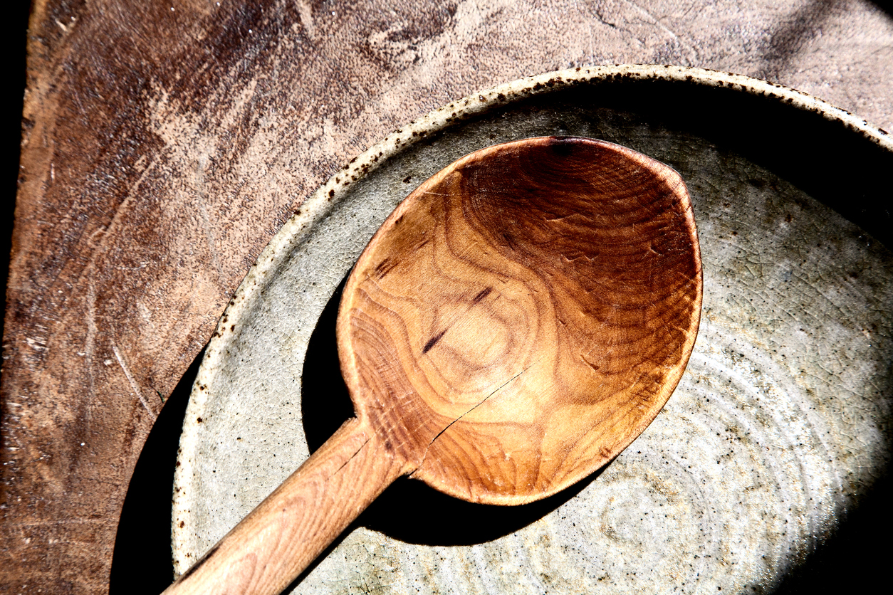 Rustic looking scene , wooden spoon in the empty plate