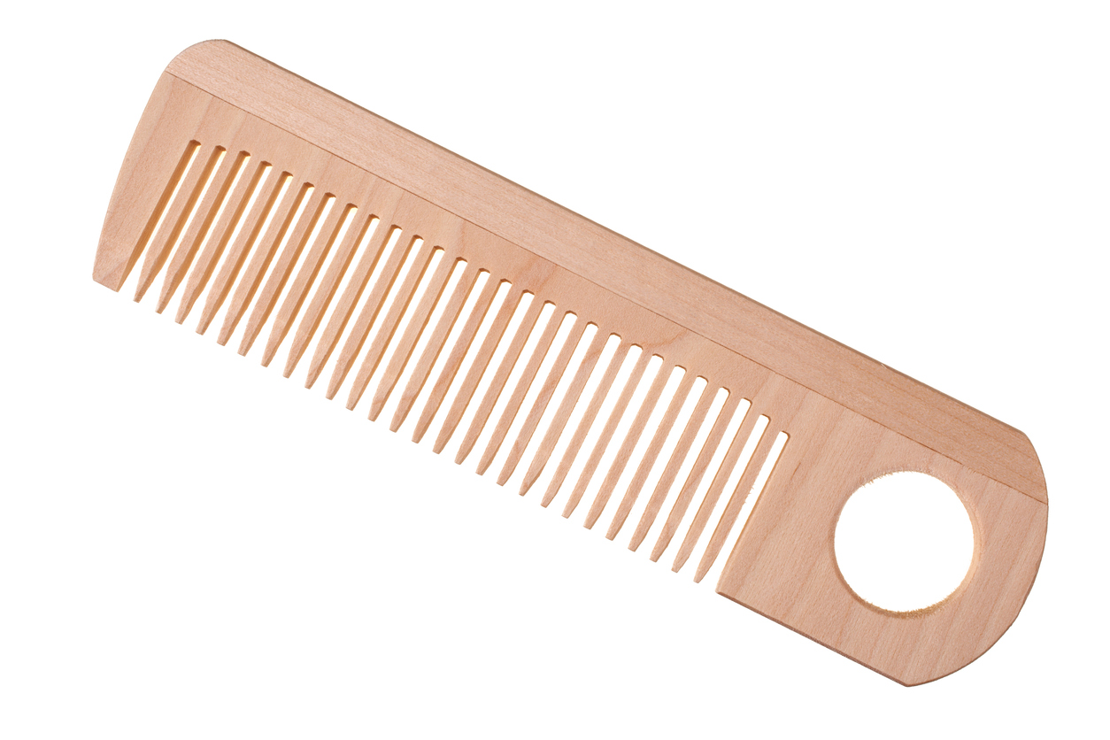 Light wooden comb isolated on white background with clipping path