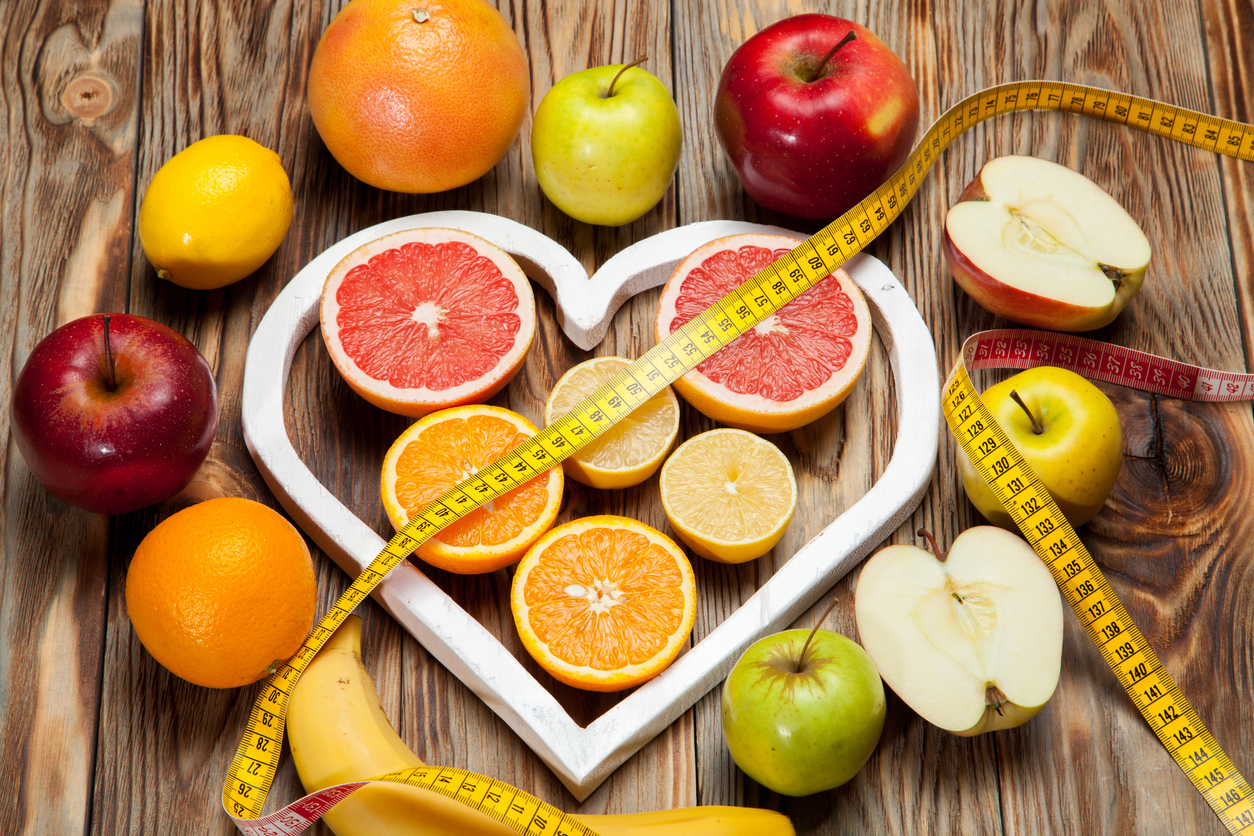 Fruit Diet, centimeter and a heart on a wooden background