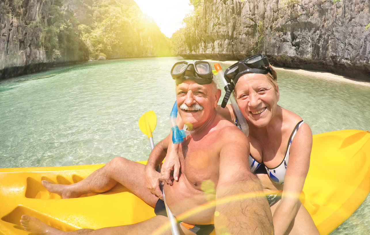 Senior couple taking selfie on kayak in El Nido lagoon