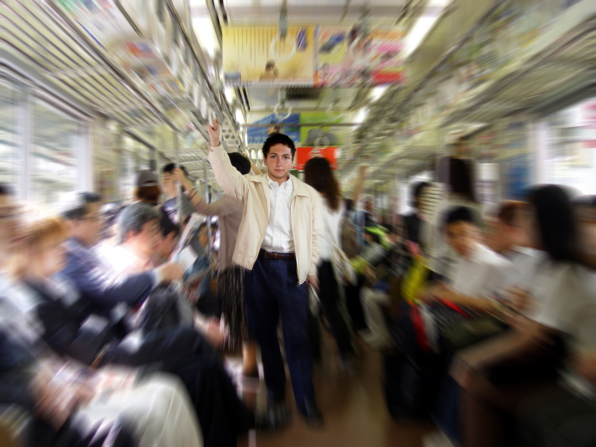 Pulled focus image of a man standing on a train